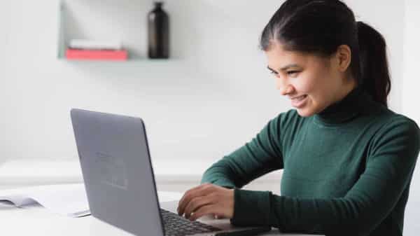 Happy woman at work on computer